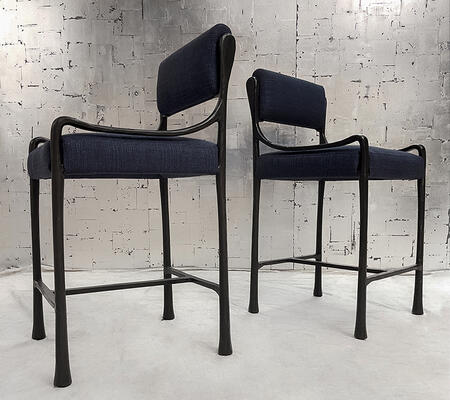 The Giac Counter Stool is defined by its sinuous cast-aluminum frame and elegant form
